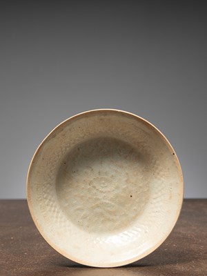 Lot 100 - (R) A CARVED AND MOULDED CELADON-GLAZED DISH CHINA SONG DYNASTY 12TH CENTURY BOWL