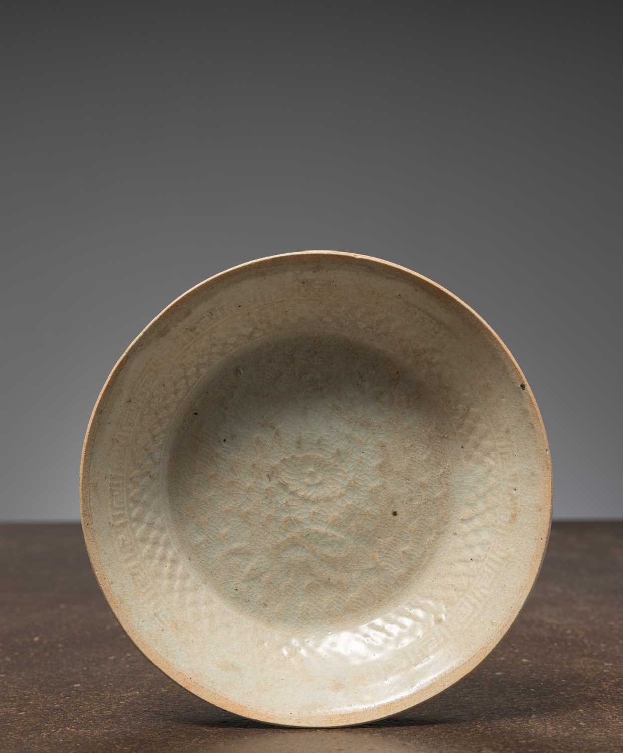 Lot 35 - (R) A CARVED AND MOULDED CELADON-GLAZED DISH, CHINA SONG DYNASTY 12TH CENTURY