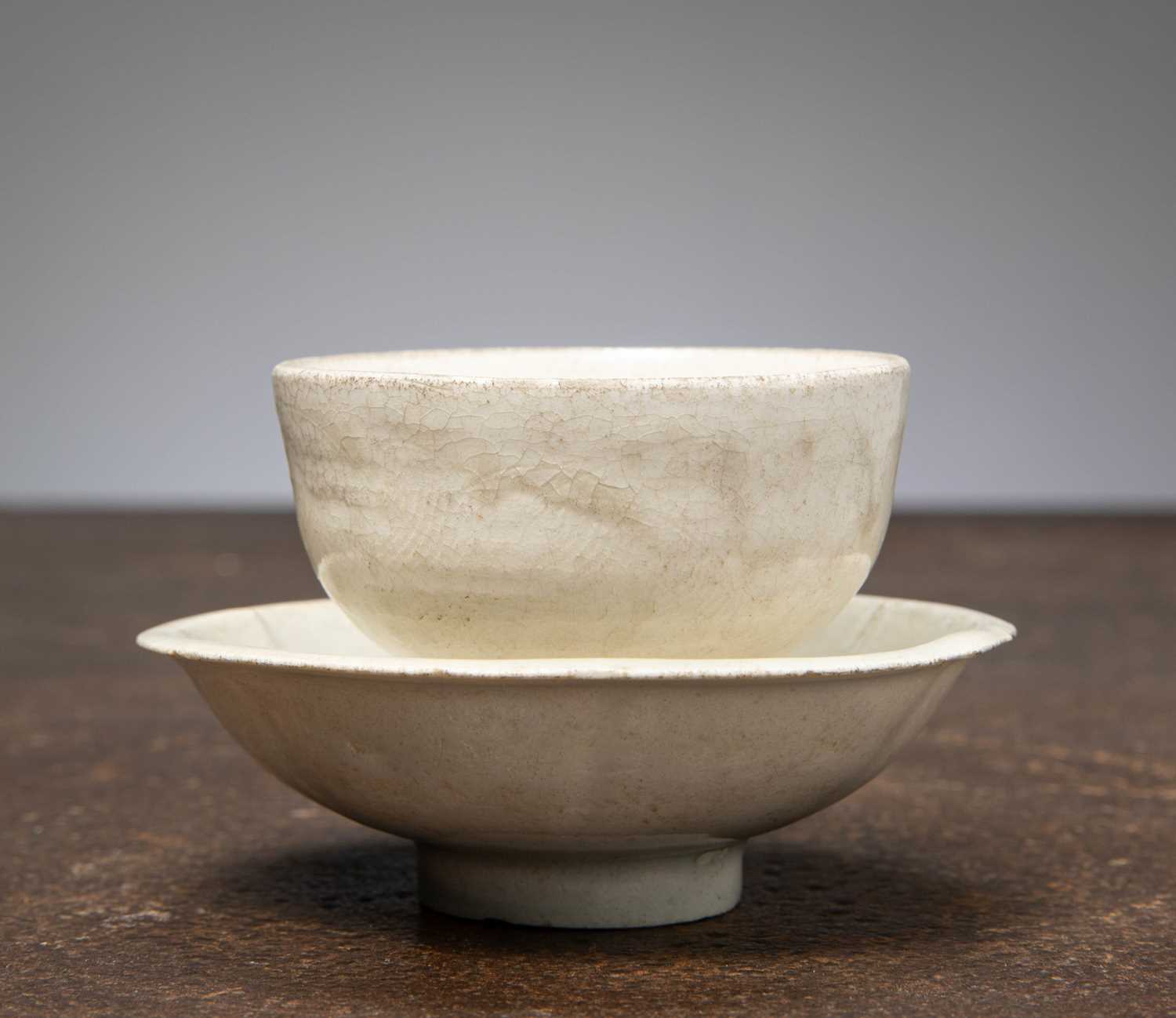 Lot 87 - (R) A WHITE-GLAZED TEA BOWL WITH MATCHING SAUCER, SONG DYNASTY (960–1279)