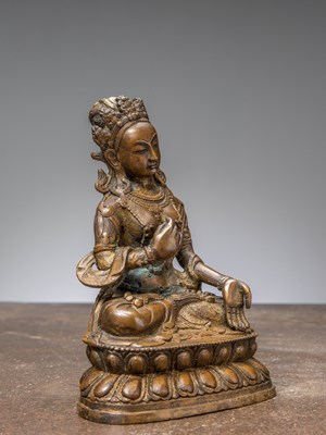 Lot 42 - A SEATED BRONZE TARA WITH REMAINS OF GILDING, CHINA QING DYNASTY
