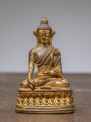 Lot 263 - A SEATED BRONZE GILT BUDDHA, NEPAL, 15TH CENTURY