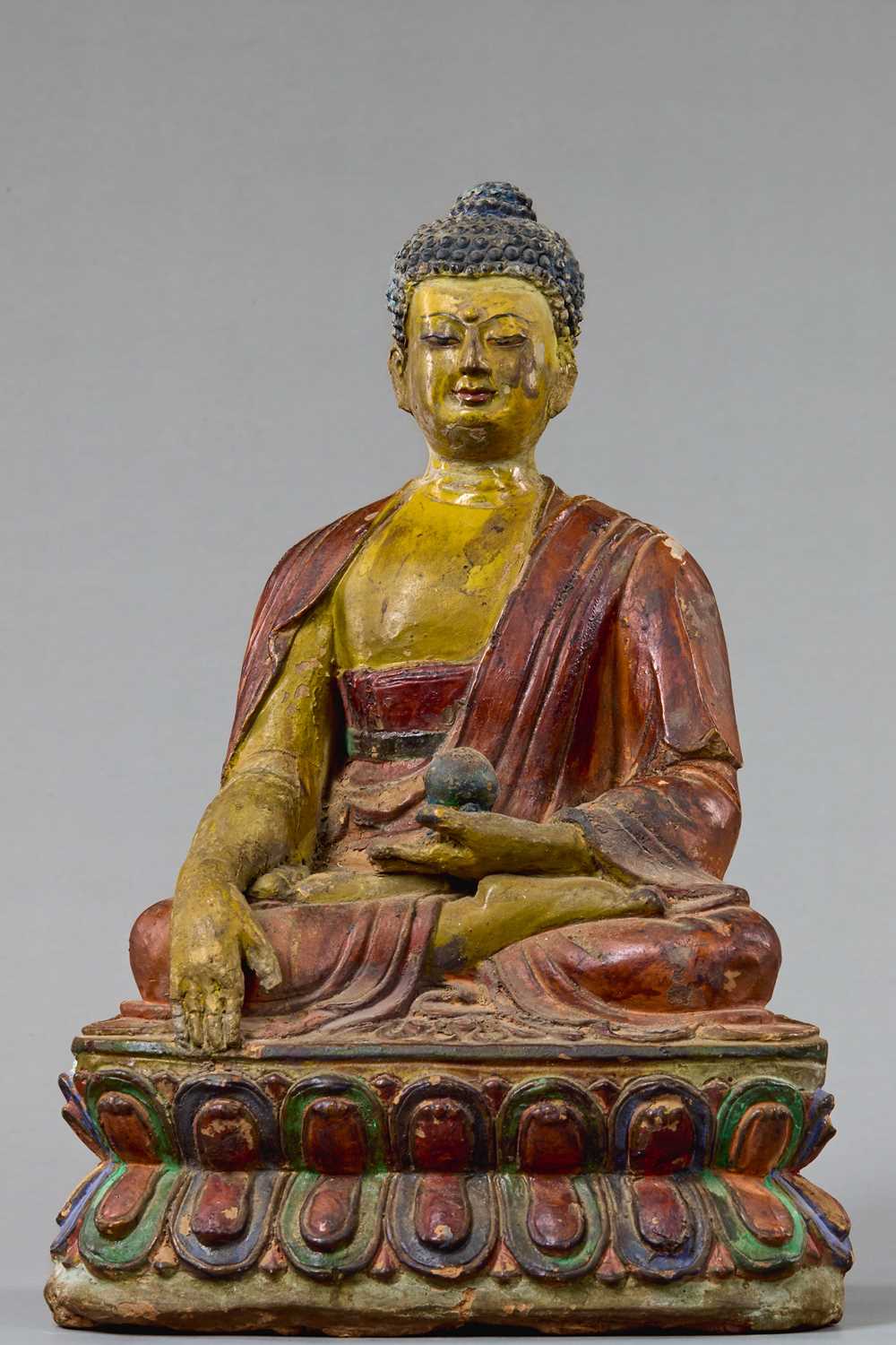 Lot 4 - A LARGE TIBETAN CLAY TSA TSA WITH POLYCHROME PIGMENTS DEPICTING BUDDHA AKSHOBYA, 18TH CENTURY