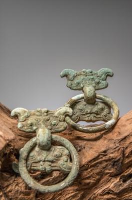 Lot 84 - (R) A PAIR OF BRONZE FITTINGS WITH TAOTIE MASKS, CHINA, WARRING STATES PERIOD, 4TH TO 3RD CENTURY BC