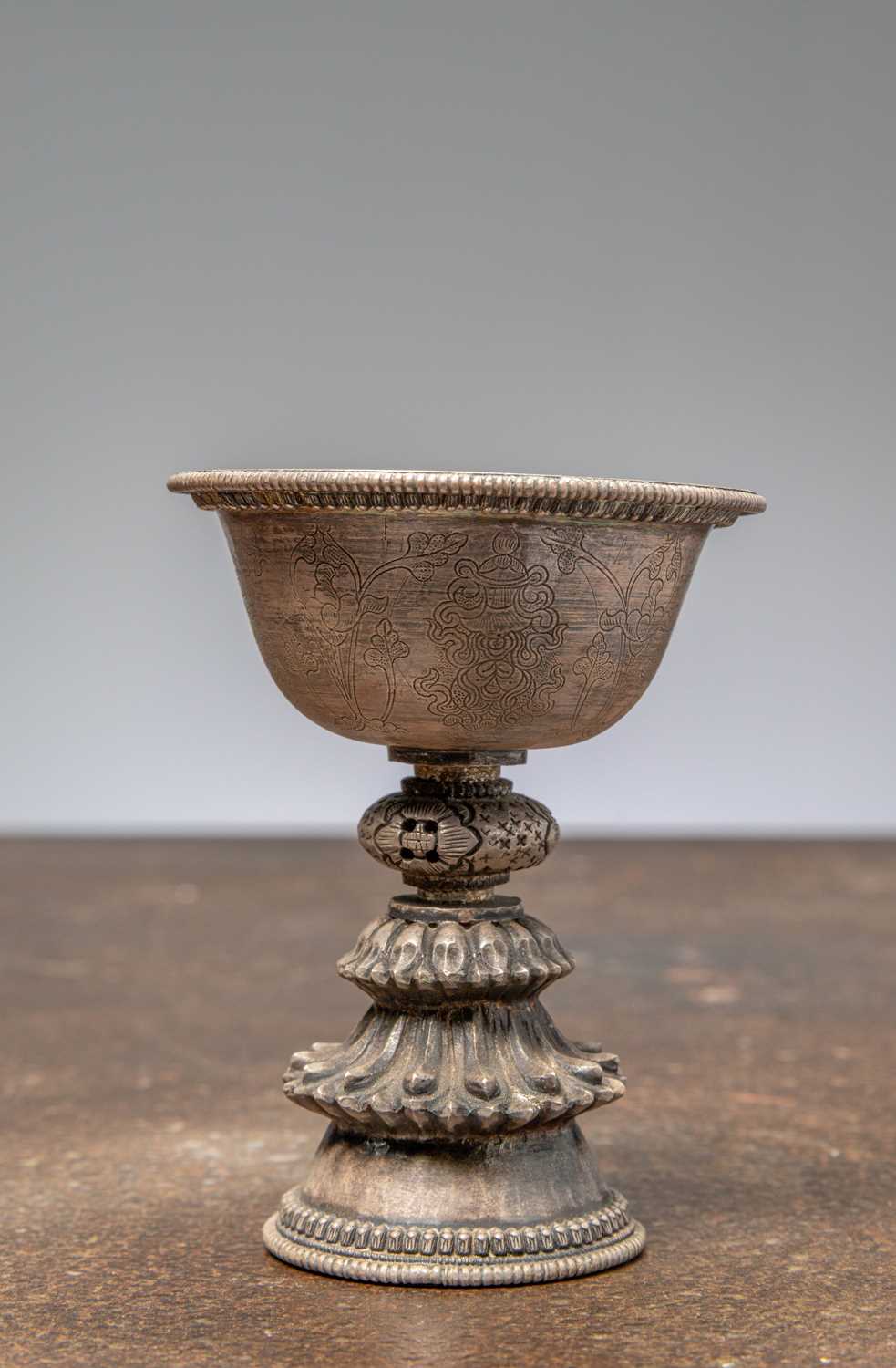 Lot 88 - (R) A SILVER EMBOSSED OFFERING LAMP, TIBET, 19TH CENTURY