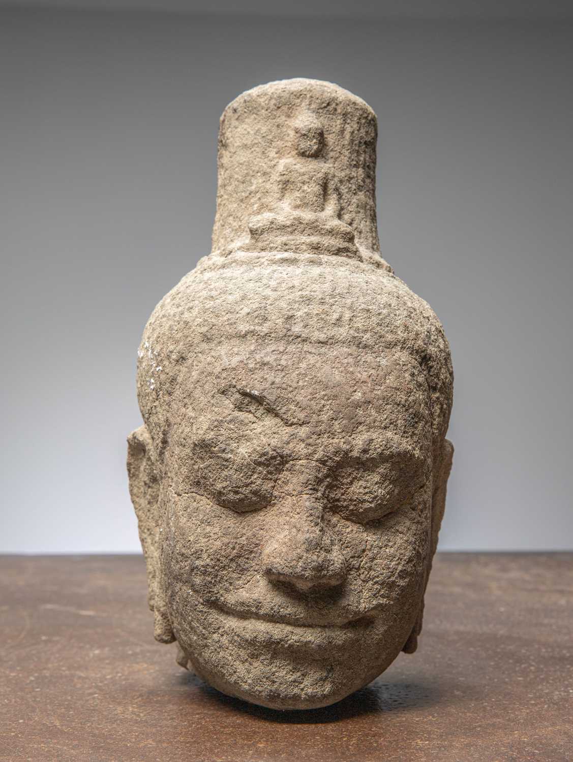 Lot 14 - (R) AN EXQUISITE KHMER SANDSTONE BUDDHIST HEAD, CAMBODIA, 12TH CENTURY