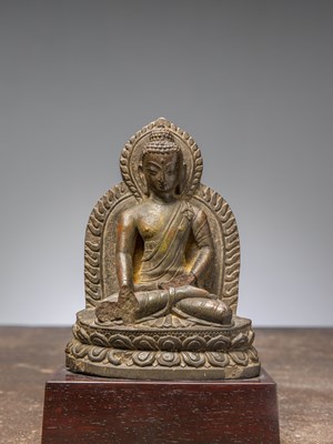 Lot 288 - A SEATED STONE CARVED RESTGILT BUDDHA, NEPAL, 16TH CENTURY