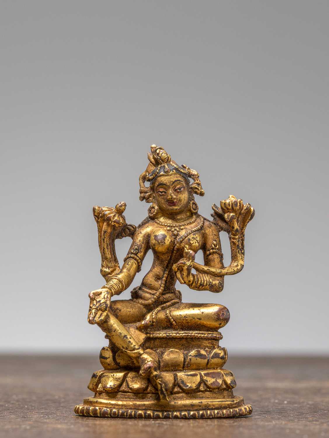 Lot 35 - A GILT-BRONZE FIGURE OF GREEN TARA, TIBET, 18TH CENTURY
