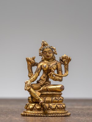Lot 35 - A GILT-BRONZE FIGURE OF GREEN TARA, TIBET, 18TH CENTURY