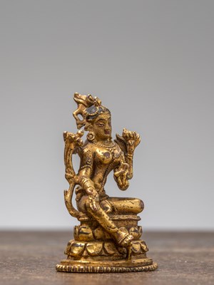 Lot 35 - A GILT-BRONZE FIGURE OF GREEN TARA, TIBET, 18TH CENTURY