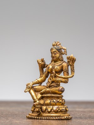 Lot 35 - A GILT-BRONZE FIGURE OF GREEN TARA, TIBET, 18TH CENTURY
