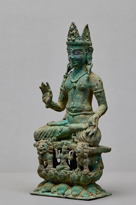 Lot 91 - SEATED BRONZE BODHISATTVA ON A LION THRONE, KASHMIR, 12TH CENTURY