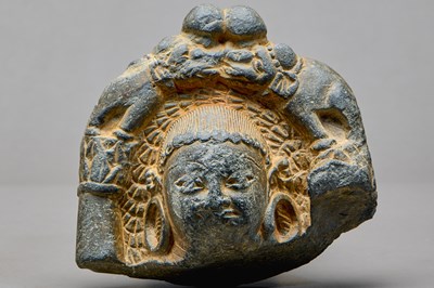 Lot 9 - STONE HEAD OF A BUDDHA WITH ATTENDANT ELEPHANTS, KASHMIR REGION, 4TH–5TH CENTURY