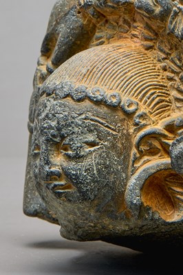 Lot 9 - STONE HEAD OF A BUDDHA WITH ATTENDANT ELEPHANTS, KASHMIR REGION, 4TH–5TH CENTURY