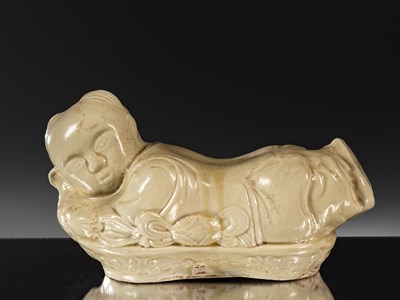 Lot 95 - PORCELAIN TING WARE WHITE CERAMIC PILLOW IN THE SHAPE OF A CHILD CHINA YUAN DYNASTY (1271-1368)