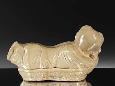 Lot 95 - PORCELAIN TING WARE WHITE CERAMIC PILLOW IN THE SHAPE OF A CHILD CHINA YUAN DYNASTY (1271-1368)