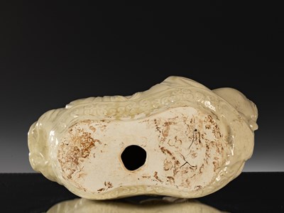 Lot 95 - PORCELAIN TING WARE WHITE CERAMIC PILLOW IN THE SHAPE OF A CHILD CHINA YUAN DYNASTY (1271-1368)
